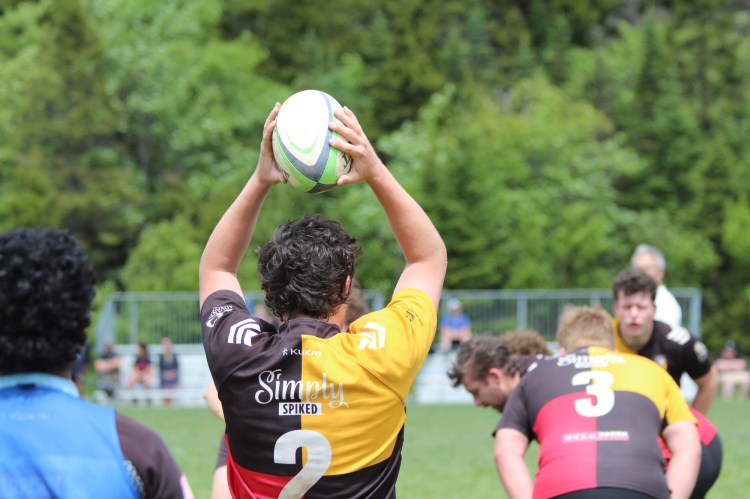 Senior mens player throwing a lineout